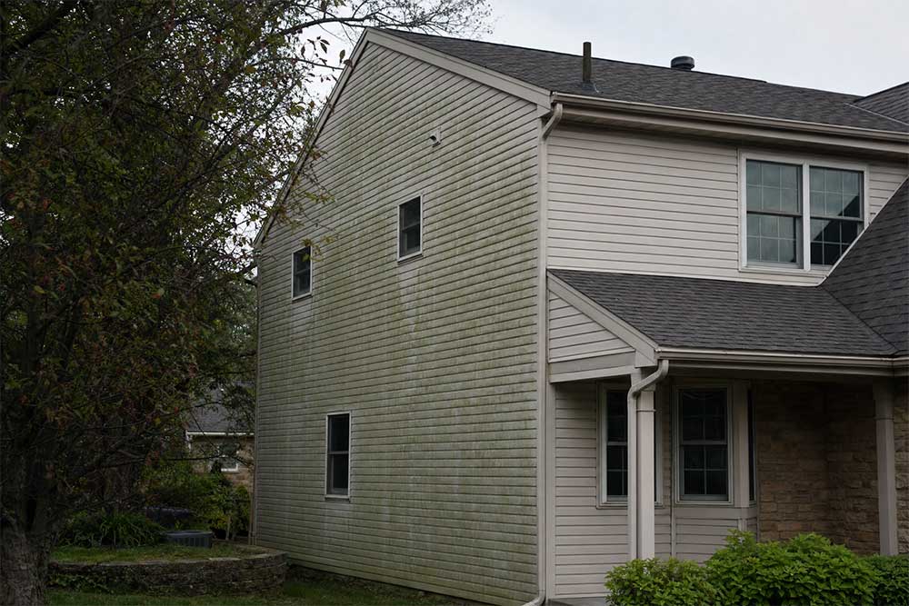 Two-story residential house in Neenah, Wisconsin, showing exterior before professional house washing and power washing services